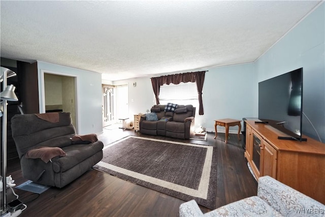 living area with baseboards, a textured ceiling, and wood finished floors
