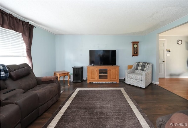 living area featuring dark wood-style flooring and baseboards
