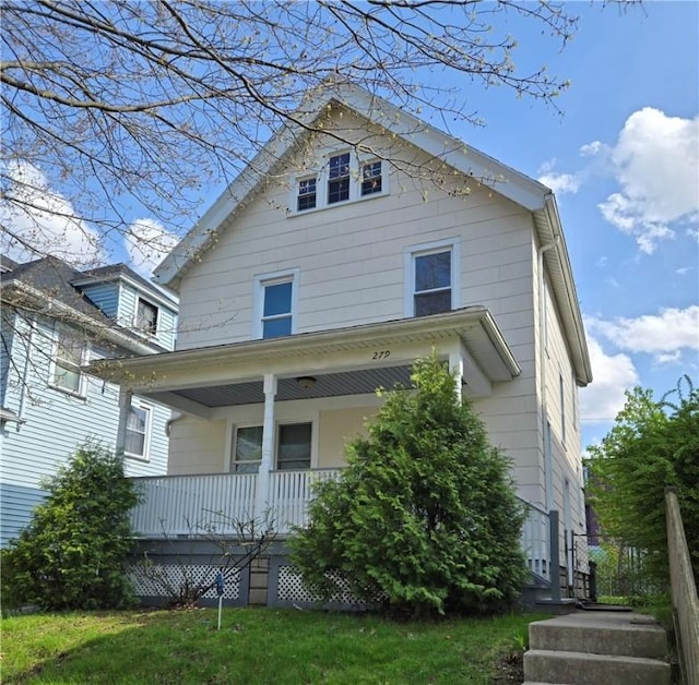 view of front facade featuring covered porch and a front yard