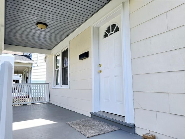 view of exterior entry with a porch