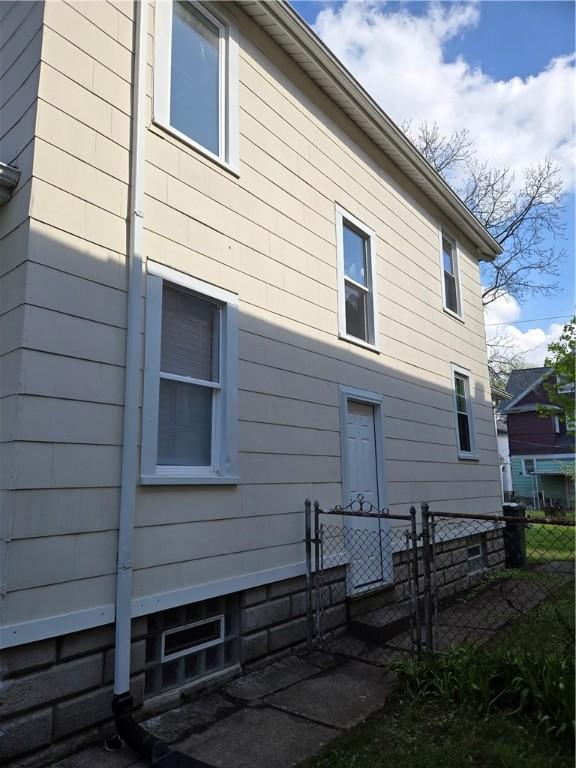 view of home's exterior featuring fence