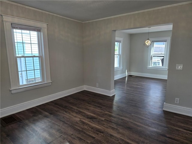 unfurnished room featuring visible vents, ornamental molding, baseboards, and dark wood-style floors