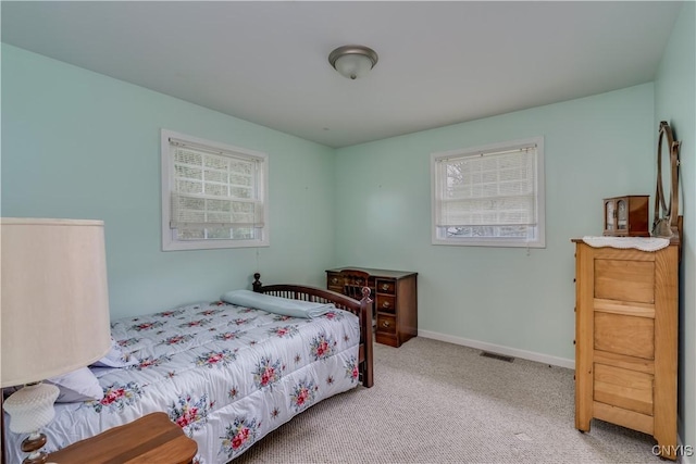 bedroom with carpet floors, baseboards, and visible vents