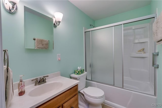 bathroom with vanity, bath / shower combo with glass door, and toilet