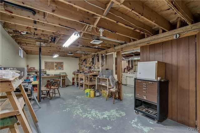 unfinished basement with a workshop area and washer / dryer