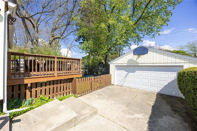 detached garage featuring fence