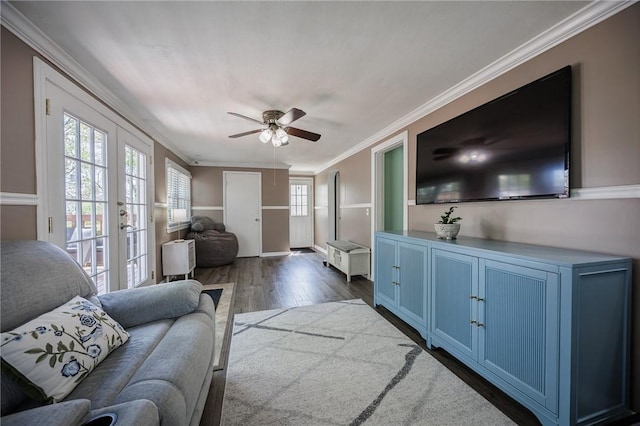 living room featuring crown molding, ceiling fan, french doors, and dark wood-style flooring