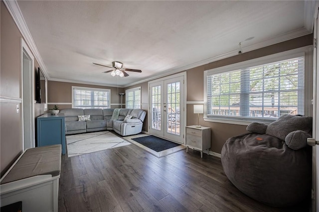 living area with ornamental molding, french doors, ceiling fan, and wood finished floors