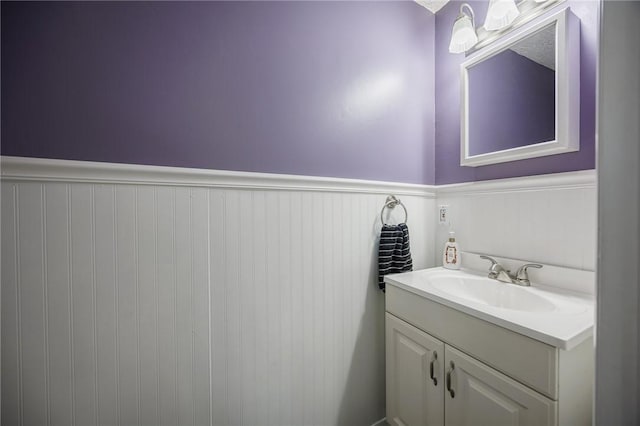 bathroom featuring vanity and a wainscoted wall