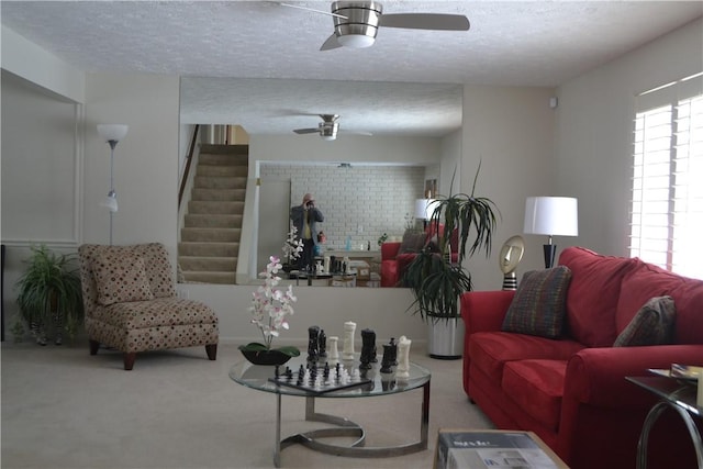86 Everwild Ln, Greece, NY 14616 - carpeted living area with a ceiling fan, a textured ceiling, and stairway