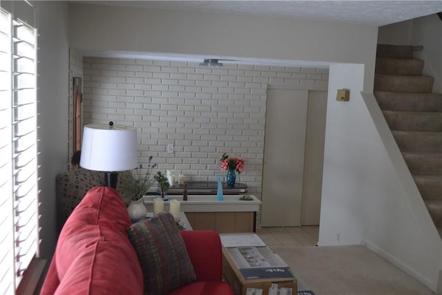 86 Everwild Ln, Greece, NY 14616 - living room with brick wall, stairs, and light tile patterned flooring