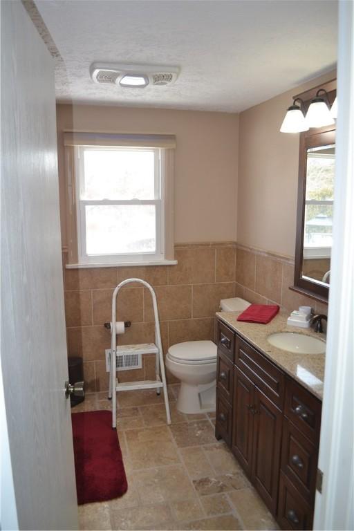 86 Everwild Ln, Greece, NY 14616 - half bath with plenty of natural light, visible vents, toilet, and tile walls