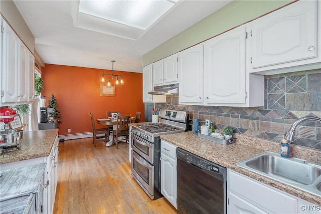 kitchen with range with two ovens, dishwasher, a sink, under cabinet range hood, and white cabinetry