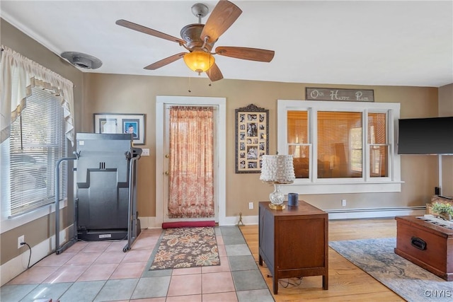entryway featuring baseboards, baseboard heating, and a ceiling fan