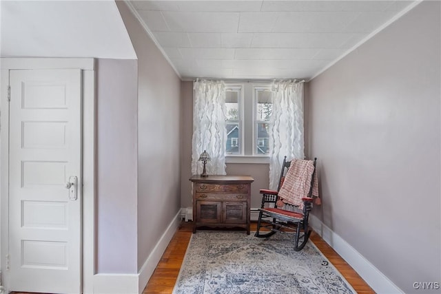 living area featuring baseboards and wood finished floors