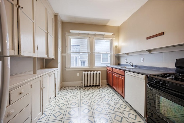 kitchen featuring dishwasher, a sink, baseboards, black gas range oven, and radiator