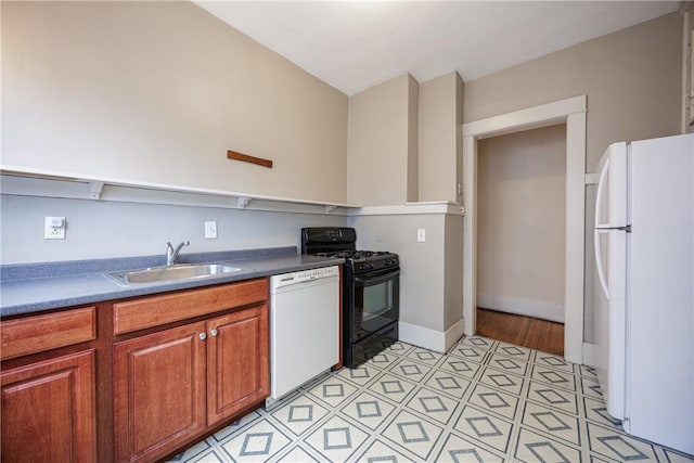kitchen featuring a sink, baseboards, brown cabinets, and white appliances