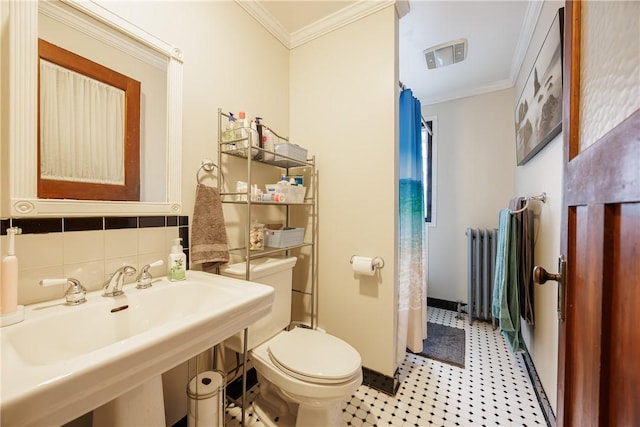 full bathroom featuring toilet, baseboards, ornamental molding, and radiator heating unit