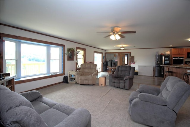 200 Mertz Rd, Bainbridge, NY 13733 - living area featuring crown molding, baseboards, ceiling fan, and light colored carpet