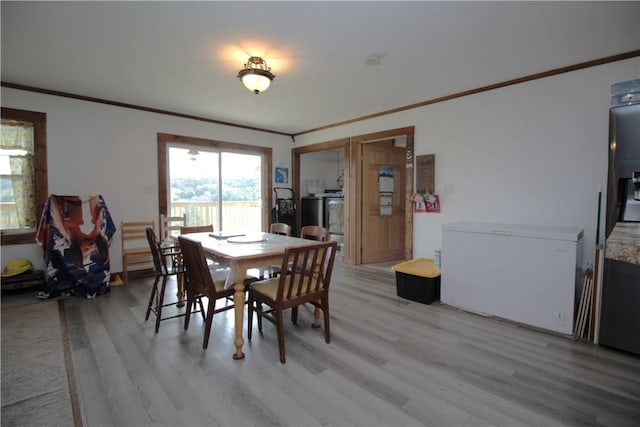 200 Mertz Rd, Bainbridge, NY 13733 - dining space with light wood-type flooring, ornamental molding, and washer / dryer