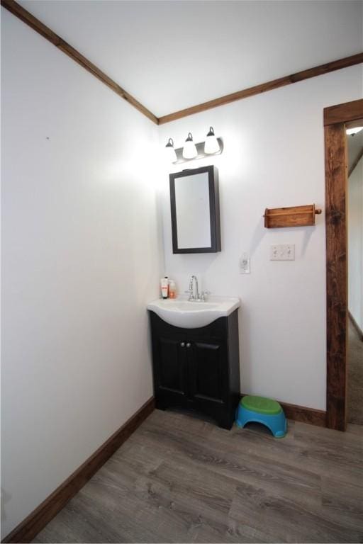 200 Mertz Rd, Bainbridge, NY 13733 - bathroom featuring vanity, baseboards, ornamental molding, and wood finished floors