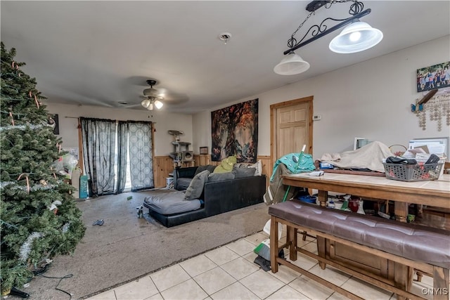 25082 Ridge Rd, Watertown-Town, NY 13601 - living area featuring light tile patterned floors, ceiling fan, wainscoting, and light colored carpet