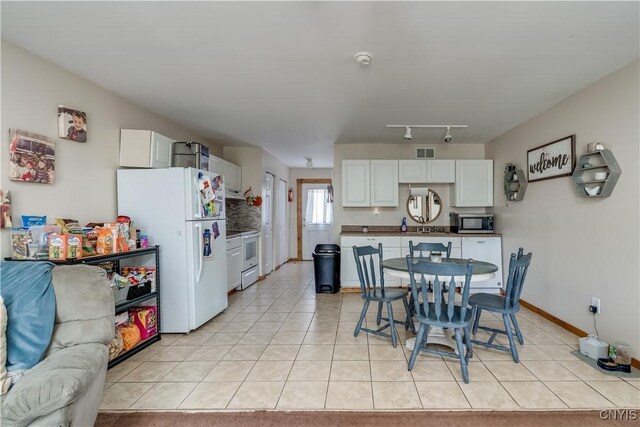 25082 Ridge Rd, Watertown-Town, NY 13601 - dining area featuring visible vents, baseboards, and light tile patterned floors