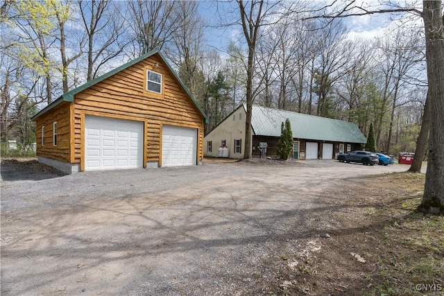 25082 Ridge Rd, Watertown-Town, NY 13601 - view of home's exterior featuring a detached garage and an outbuilding