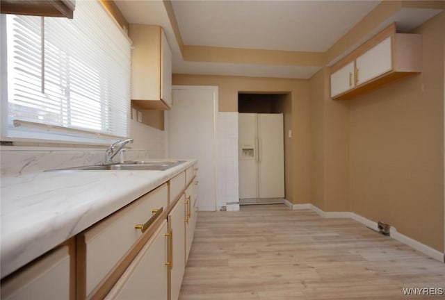 1126 La Salle Ave, Niagara Falls, NY 14301 - kitchen featuring light stone countertops, baseboards, white refrigerator with ice dispenser, light wood-type flooring, and a sink