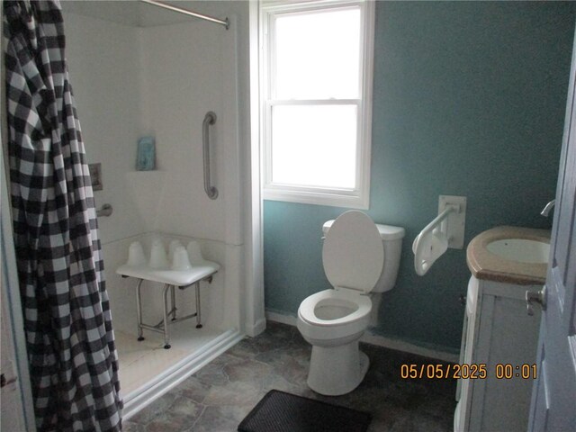 26 Balcom Ave, Corning, NY 14830 - full bathroom with baseboards, a shower with shower curtain, vanity, toilet, and stone finish floors