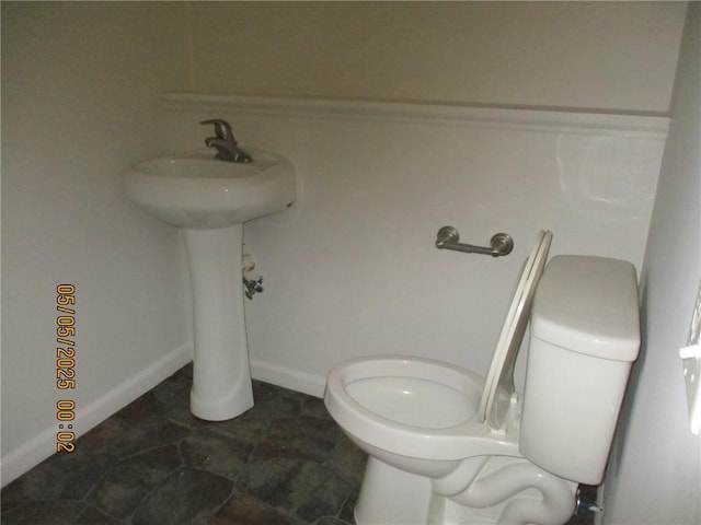 26 Balcom Ave, Corning, NY 14830 - bathroom with toilet, a sink, and baseboards