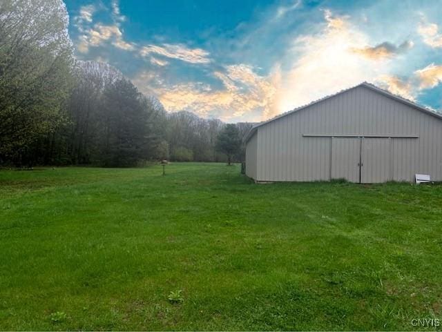 yard at dusk with an outbuilding and an outdoor structure