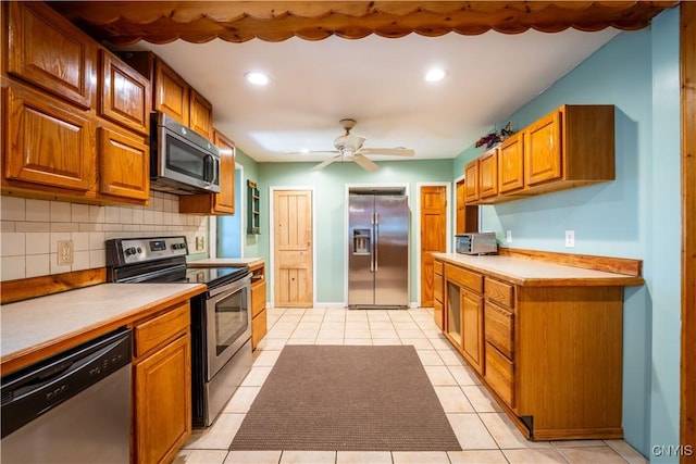 11511 State Route 26, Ava, NY 13303 - kitchen featuring ceiling fan, backsplash, stainless steel appliances, and brown cabinets