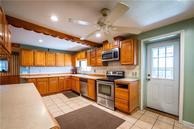 11511 State Route 26, Ava, NY 13303 - kitchen with decorative backsplash, ceiling fan, appliances with stainless steel finishes, light countertops, and a sink
