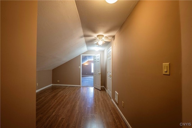 11511 State Route 26, Ava, NY 13303 - additional living space featuring vaulted ceiling, baseboards, a ceiling fan, and dark wood-type flooring