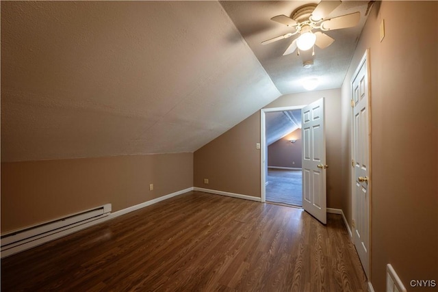 11511 State Route 26, Ava, NY 13303 - additional living space with baseboard heating, a ceiling fan, baseboards, dark wood-type flooring, and vaulted ceiling