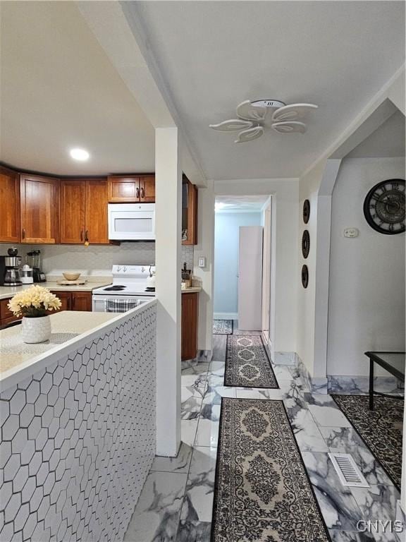 hallway with visible vents, arched walkways, and marble finish floor