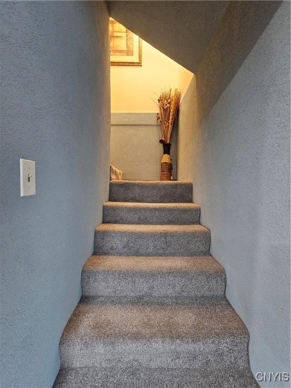 stairway with a textured wall