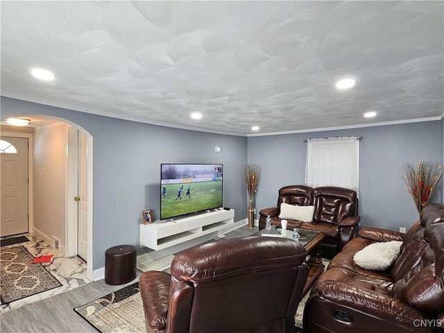 living area featuring recessed lighting, arched walkways, and ornamental molding