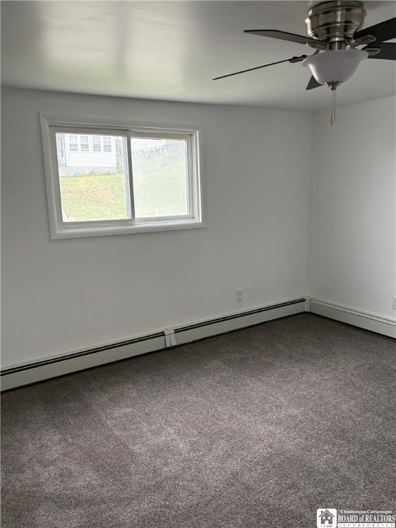 spare room featuring carpet floors, a baseboard radiator, and ceiling fan