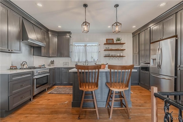 kitchen with open shelves, premium range hood, light wood-type flooring, light countertops, and appliances with stainless steel finishes