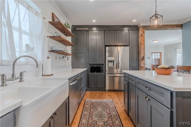 kitchen with open shelves, a sink, stainless steel appliances, light wood-type flooring, and ornamental molding