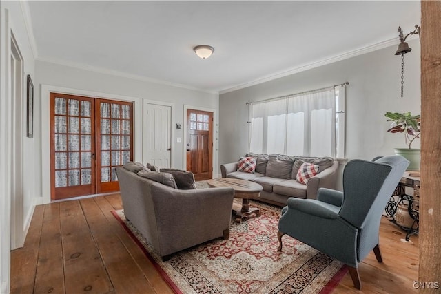 living room with wood-type flooring and crown molding
