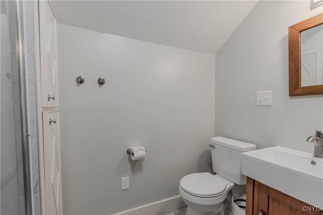 bathroom with toilet, baseboards, and vanity