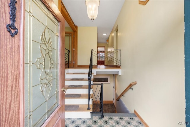 staircase featuring baseboards