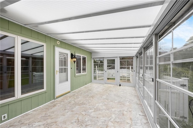 unfurnished sunroom featuring beamed ceiling