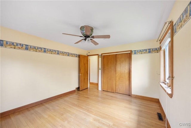 unfurnished bedroom featuring baseboards, a closet, light wood-style flooring, and visible vents