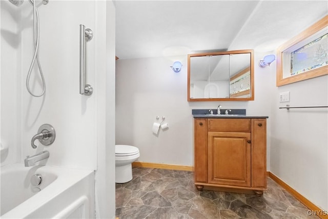 bathroom with baseboards, shower / bath combination, toilet, and vanity