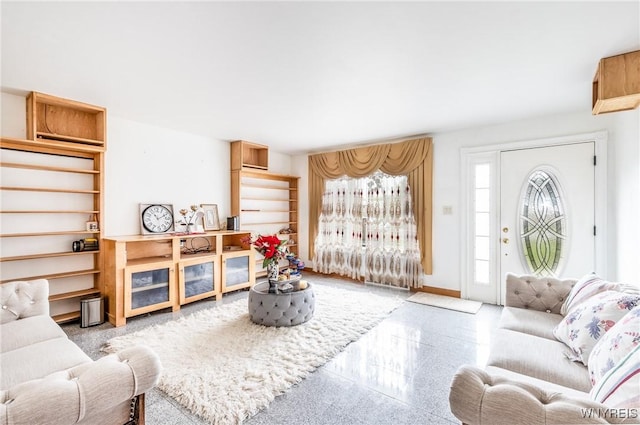 living room featuring baseboards and granite finish floor