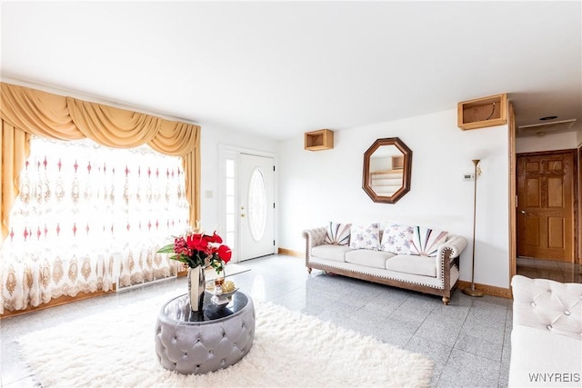 living area featuring baseboards